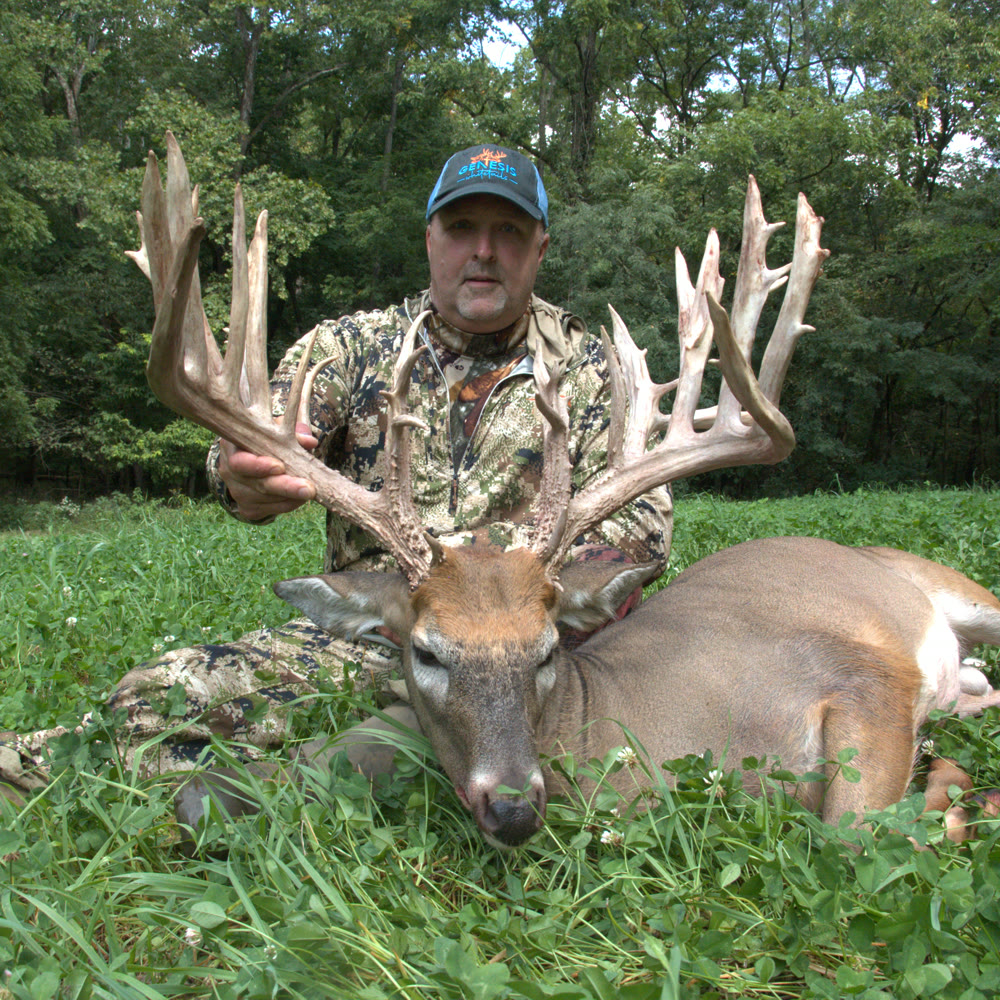 Lou with the wide-framed whitetail buck he harvested at Genesis Whitetails