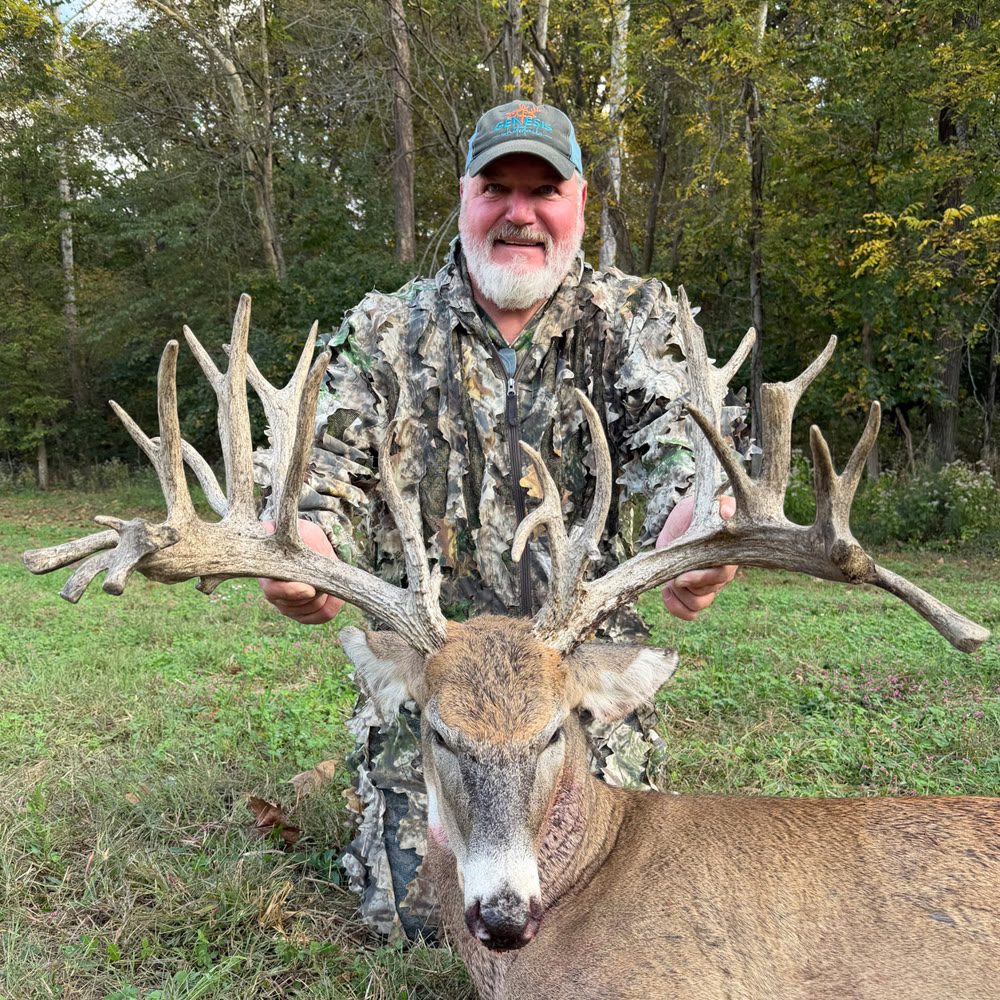 Hunter with a Platinum-class whitetail buck harvested at Genesis Whitetails